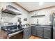 A modern kitchen features stainless steel appliances, dark cabinets and subway tile backsplash at 6655 Teeters Ln, Martinsville, IN 46151