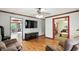 Spacious living room featuring hardwood floors, comfortable seating, and a large television at 6655 Teeters Ln, Martinsville, IN 46151