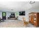 Spacious living room with a wood-burning stove, comfortable seating, and a large window at 6655 Teeters Ln, Martinsville, IN 46151