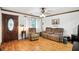Comfortable living room with hardwood floors, ample seating, and a decorative front door at 6655 Teeters Ln, Martinsville, IN 46151