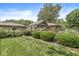 Well-maintained backyard featuring a covered patio, lush landscaping, and a charming brick house, perfect for outdoor relaxation at 7125 Chandler Dr, Indianapolis, IN 46217