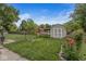 Backyard with a large shed, greenery and flowers at 7125 Chandler Dr, Indianapolis, IN 46217