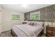 Bedroom with dark floral wallpaper, a wood bed frame and two windows at 7125 Chandler Dr, Indianapolis, IN 46217