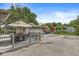 View of the detached garage and patio area with a table, umbrella and chairs at 7125 Chandler Dr, Indianapolis, IN 46217