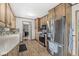 Efficient kitchen with wood cabinets, stainless steel appliances, and easy access to the living spaces at 7125 Chandler Dr, Indianapolis, IN 46217