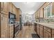 Well-appointed kitchen featuring wood cabinets, a dining area, and ample natural light for cooking enjoyment at 7125 Chandler Dr, Indianapolis, IN 46217