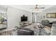 Open-concept living room with modern decor, a flat-screen TV, and ample space for entertaining guests at 7125 Chandler Dr, Indianapolis, IN 46217