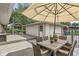 Covered patio with a dining table, seating and an umbrella at 7125 Chandler Dr, Indianapolis, IN 46217