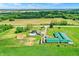 Expansive aerial view of a farm featuring a house, pool, barn, and lush green fields with mature trees at 7165 W State Road 252 W Rd, Edinburgh, IN 46124