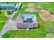 An aerial view showcases the property's layout, pool, lush greenery, and surrounding landscape at 7165 W State Road 252 W Rd, Edinburgh, IN 46124