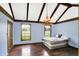 Bedroom with vaulted ceiling, rustic chandelier, hardwood floors, and ample natural light at 7165 W State Road 252 W Rd, Edinburgh, IN 46124