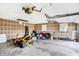 A spacious garage featuring high ceilings, a lawnmower, and ample storage at 7165 W State Road 252 W Rd, Edinburgh, IN 46124