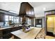 A well-lit kitchen with an island cooktop, plenty of counter space, and charming blue wallpaper at 7165 W State Road 252 W Rd, Edinburgh, IN 46124