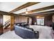 Living room offers wood paneling, exposed beams, and an entryway to carpeted staircase at 7165 W State Road 252 W Rd, Edinburgh, IN 46124