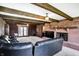 Living room features wood paneling, exposed wood beams, brick fireplace, and an access to patio at 7165 W State Road 252 W Rd, Edinburgh, IN 46124