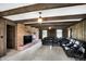 Living room features wood paneling, exposed wood beams, and a brick fireplace with a flatscreen TV at 7165 W State Road 252 W Rd, Edinburgh, IN 46124