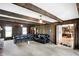 Spacious living room with wood paneling, exposed beams, and a view of the kitchen at 7165 W State Road 252 W Rd, Edinburgh, IN 46124