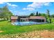 A backyard pool with slide, patio, and a charming home with mature trees and well-maintained lawn at 7165 W State Road 252 W Rd, Edinburgh, IN 46124