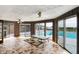 Bright sunroom with tile flooring, ceiling fans, and sliding doors to the pool area at 7165 W State Road 252 W Rd, Edinburgh, IN 46124
