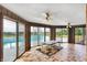 Bright sunroom with tile flooring, ceiling fans, and sliding doors to the pool area at 7165 W State Road 252 W Rd, Edinburgh, IN 46124