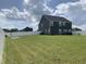 Expansive backyard showcasing lush green grass, white fencing, and a well-maintained landscape at 7270 W Stone Pass, New Palestine, IN 46163