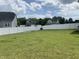 Spacious backyard with a lush lawn, surrounded by a white fence for privacy and security at 7270 W Stone Pass, New Palestine, IN 46163