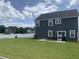 Large backyard with a patio, perfect for outdoor dining and relaxation, surrounded by lush green grass at 7270 W Stone Pass, New Palestine, IN 46163
