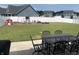 Large backyard featuring a black outdoor dining set, providing a great space for entertaining and relaxation at 7270 W Stone Pass, New Palestine, IN 46163