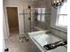 Bathroom featuring a bathtub, separate shower with glass door, and modern fixtures at 7270 W Stone Pass, New Palestine, IN 46163