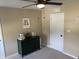 Neutral bedroom with a modern ceiling fan, green dresser, and a personalized letter initial wall hanging at 7270 W Stone Pass, New Palestine, IN 46163