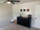 Bright bedroom featuring a black dresser, ceiling fan, and artwork displayed on the white walls at 7270 W Stone Pass, New Palestine, IN 46163