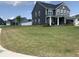 Beautiful two-story home with a manicured front lawn, showcasing its curb appeal and inviting entrance at 7270 W Stone Pass, New Palestine, IN 46163