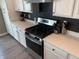 Featuring stainless steel appliances and quartz countertops and sleek black herringbone backsplash, this kitchen is gorgeous at 7270 W Stone Pass, New Palestine, IN 46163