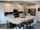 Modern kitchen with white cabinetry, quartz countertops, and an island with seating and stainless steel appliances at 7270 W Stone Pass, New Palestine, IN 46163