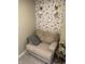 Cozy nook featuring plush armchair, decorative wallpaper, and stylish sconce lighting for a relaxing ambiance at 7270 W Stone Pass, New Palestine, IN 46163