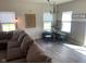 Bright and airy living room features modern decor and ample natural light from multiple windows at 7270 W Stone Pass, New Palestine, IN 46163
