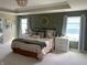 Comfortable main bedroom featuring tray ceilings, natural light, and neutral décor at 7270 W Stone Pass, New Palestine, IN 46163