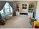 Spacious playroom with ample natural light, featuring built-in shelving and plenty of toys for children at 7270 W Stone Pass, New Palestine, IN 46163