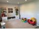 Inviting playroom with shelving units, toys, and a bench with storage, ideal for creative play at 7270 W Stone Pass, New Palestine, IN 46163