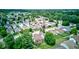 A panoramic aerial view displays a sprawling residential area with diverse homes, green spaces, and tree-covered landscapes at 741 Chestnut Ln, Brownsburg, IN 46112