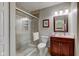 Tiled bathroom featuring glass-enclosed shower and cherry wood vanity at 741 Chestnut Ln, Brownsburg, IN 46112