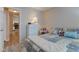 Inviting bedroom featuring a patchwork quilt, a tall dresser, and a view into the kitchen at 741 Chestnut Ln, Brownsburg, IN 46112