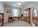 Guest bedroom showcasing display cabinet and window at 741 Chestnut Ln, Brownsburg, IN 46112