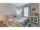 Comfortable bedroom with a decorative quilt, side table, and an accent cabinet at 741 Chestnut Ln, Brownsburg, IN 46112