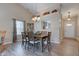 Bright dining room with wood floors, a china cabinet, and open view of the kitchen at 741 Chestnut Ln, Brownsburg, IN 46112