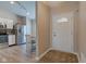 Inviting entryway that flows into a bright kitchen and dining area, highlighting the open layout and modern flooring at 741 Chestnut Ln, Brownsburg, IN 46112