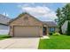 Charming single-story brick home with a two-car garage, manicured lawn, and a welcoming garden at 741 Chestnut Ln, Brownsburg, IN 46112