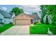 Charming single-story brick home with a two-car garage, manicured lawn, and a welcoming garden at 741 Chestnut Ln, Brownsburg, IN 46112