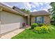 Charming home with blue shutters, a well-manicured lawn, and colorful flowers, creating a welcoming entrance at 741 Chestnut Ln, Brownsburg, IN 46112
