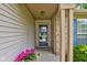 Cozy front porch with a decorative door, potted flowers, and a 'Welcome' mat, providing a warm greeting at 741 Chestnut Ln, Brownsburg, IN 46112